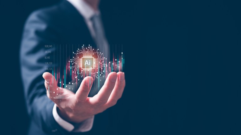 A person's hand is seen holding a ball of AI technology in their palm to represent the trading and digital transformation for businesses in the age of AI hyperintelligence (Getty Images).