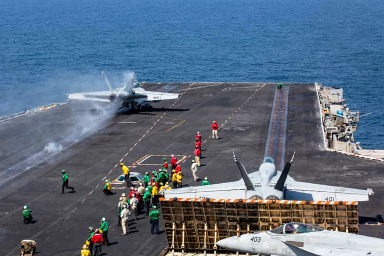 This image provided by U.S. Central Command shows a F/A-18E Super Hornet launching from the flight deck of Nimitz-class aircraft carrier USS Abraham Lincoln