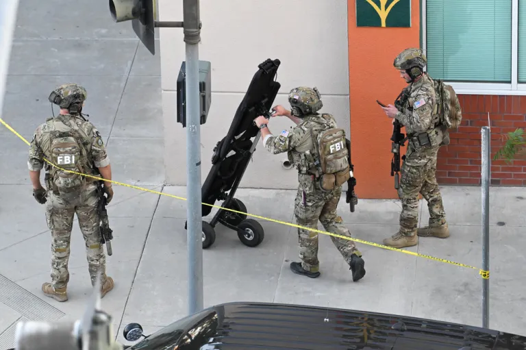 FBI agents respond after a man barricaded himself inside a building with hostages.