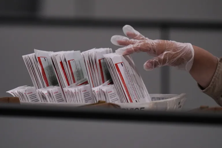 A worker inspects a ballot the day after California's primary election.