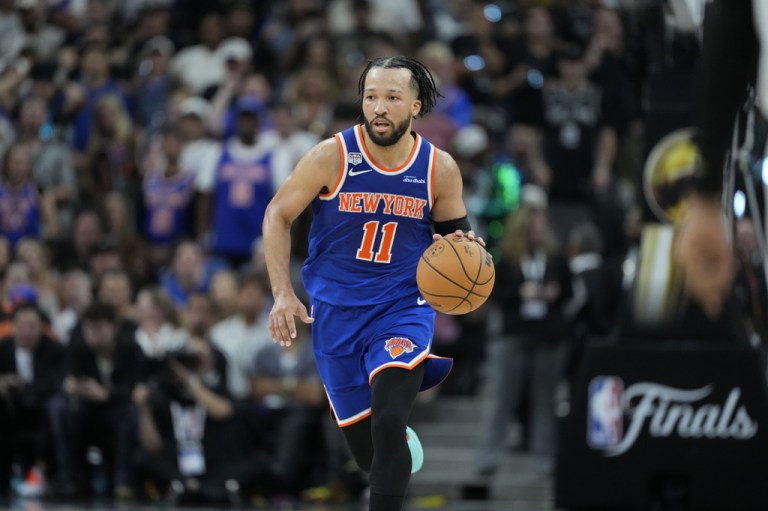 New York Knicks guard Jalen Brunson moves the ball up court against the San Antonio Spurs during the second half of Game 5 of the NBA Finals basketball series, Saturday, June 13, 2026, in San Antonio.