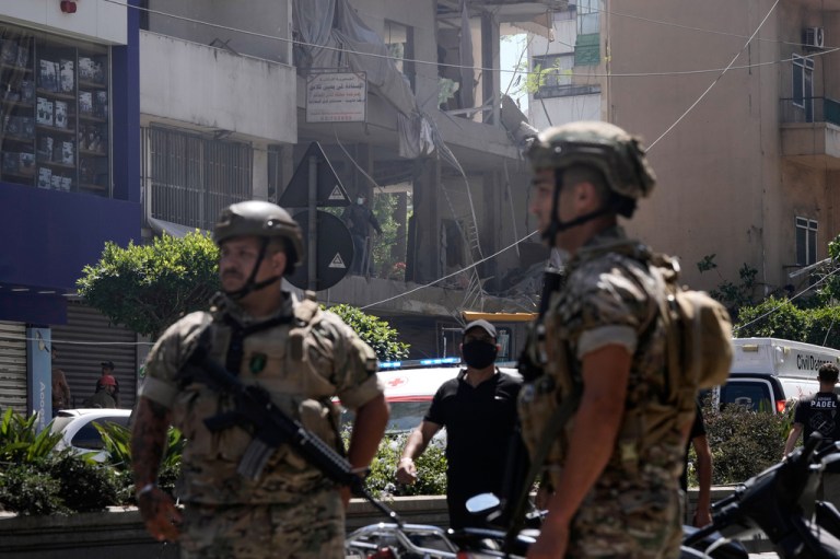 Lebanese soldiers stand guard at the site of an Israeli airstrike that struck an apartment in Daniyeh, Beirut