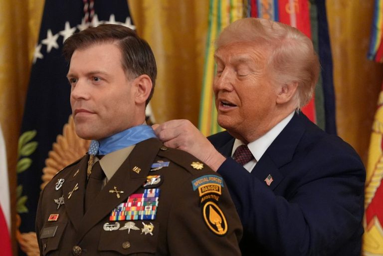 President Donald Trump, right, awards the Medal of Honor to retired Army Maj. Nicholas Dockery, in the East Room of the White House, Thursday, June 18, 2026, in Washington. (AP Photo/Jacquelyn Martin)