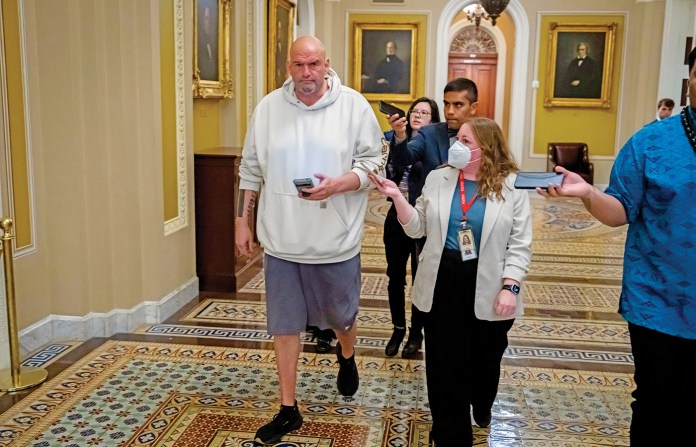 Sen. John Fetterman (D-PA) walks outside the Senate, March 14, 2025. (Ben Curtis/AP)