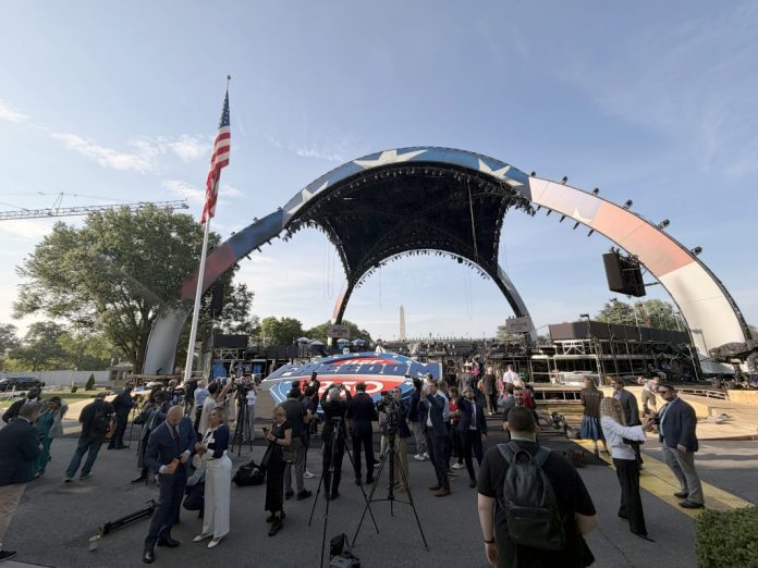 Members of the press gather in front of the UFC FREEDOM 250 medallion in front of the main venue. (Judith Y. Kim/Washington Examiner)