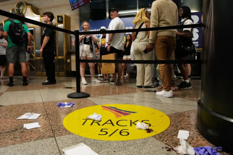 People stand near an area roped off after a stabbing at Penn Station on Sunday, June 7, 2026, in New York.