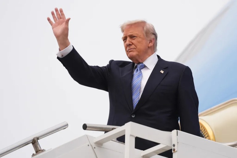 President Donald Trump waves as he boards Air Force One.