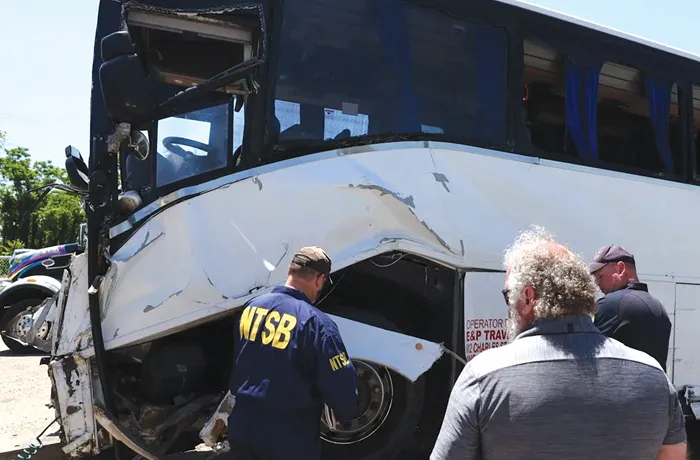 An NTSB investigator examines wreckage on May 30 from the deadly bus crash on I-95 in Stafford County, Virginia. (Courtesy of the NTSB)