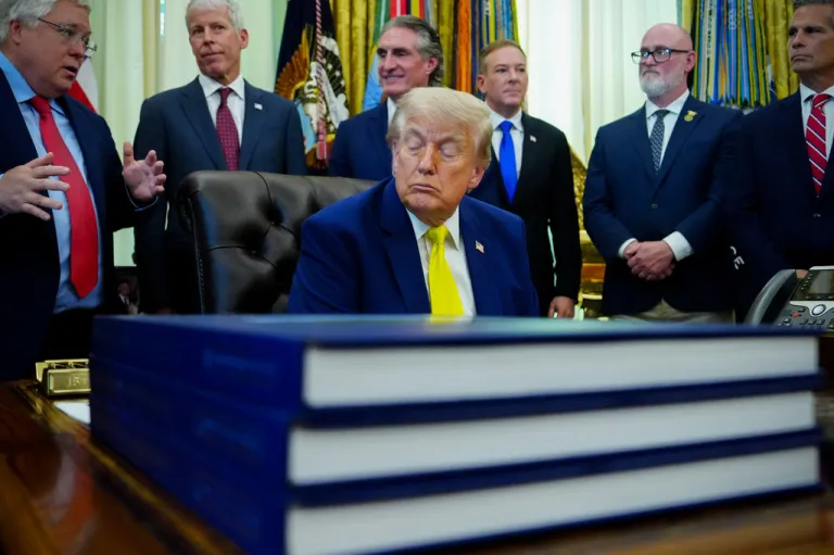 President Donald Trump listens during an event in the Oval Office of the White House.